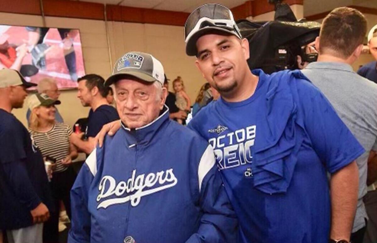 Felipe Ruiz, right, stands next to Dodgers legend Tommy Lasorda.