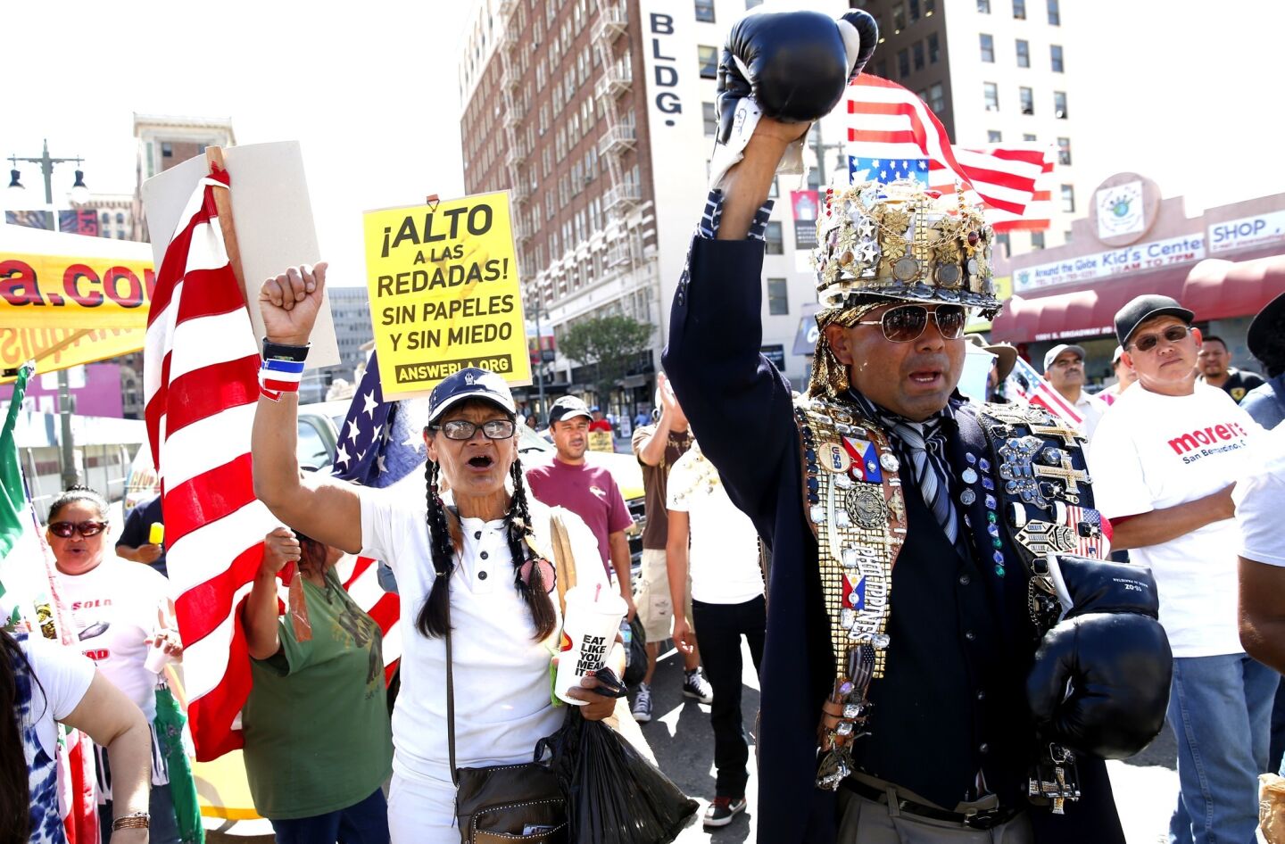 People rally for immigration reform on Broadway Street during May Day protests in downtown Los Angeles.