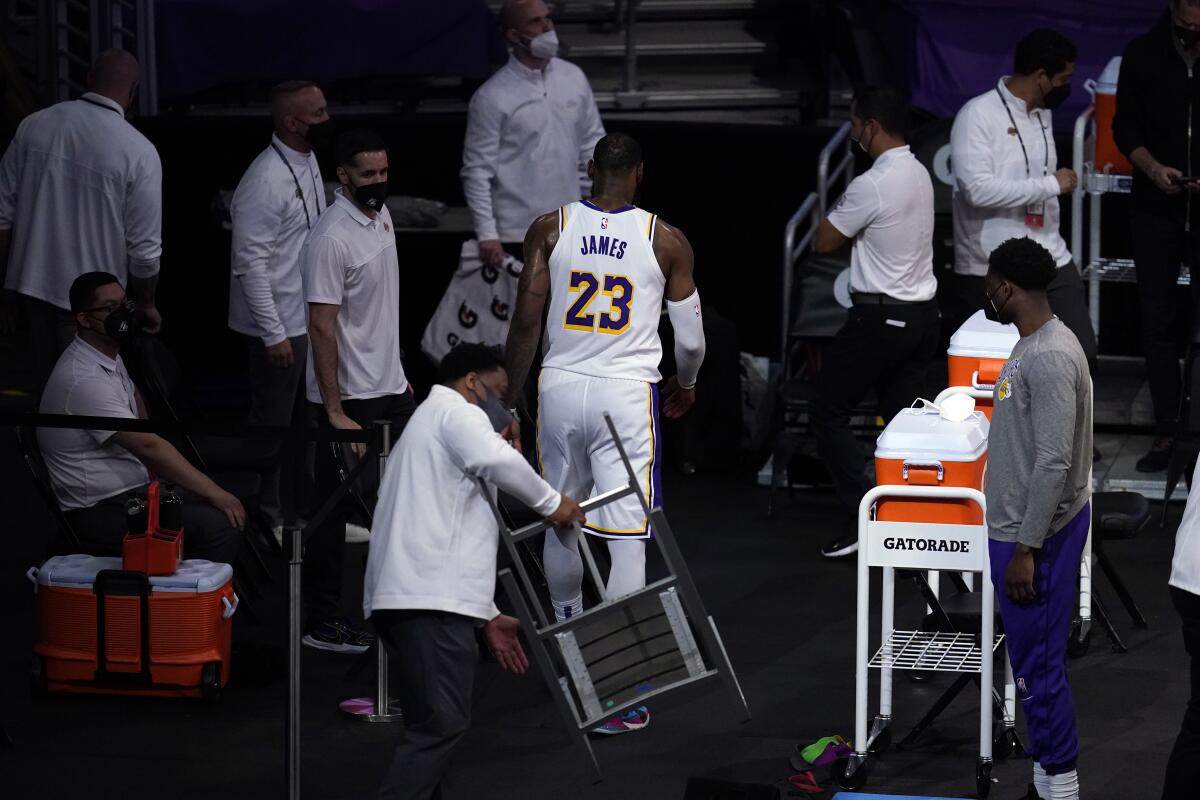 Lakers forward LeBron James walks to the locker room after kicking a chair following an injury March 20, 2021.