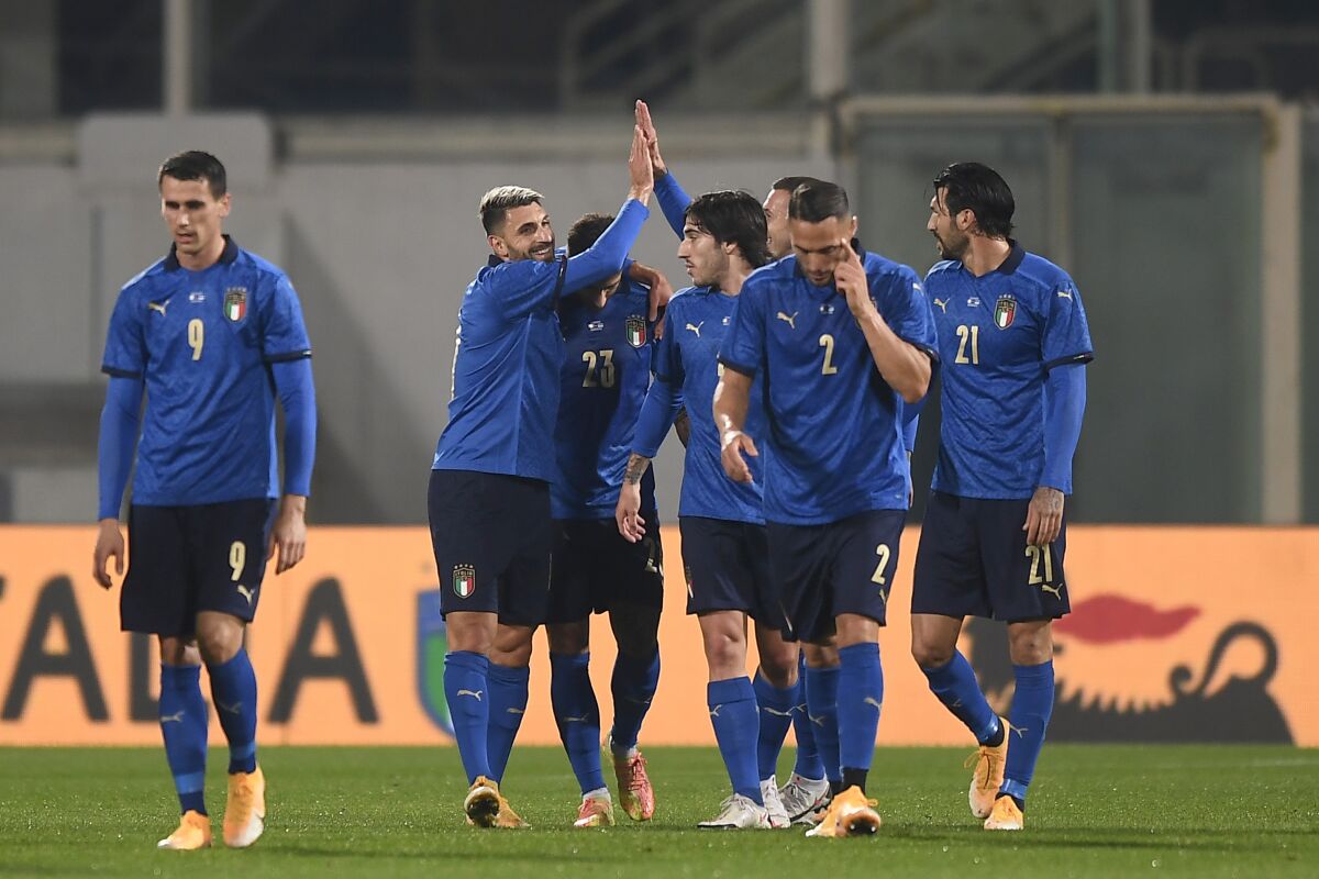 Italy's Vincenzo Grifo, second left, celebrates with teammates after scoring his side's first goal of the game during the international friendly soccer match between Italy and Estonia, at the Artemio Franchi Stadium in Florence, Italy, Wednesday, Nov. 11, 2020. (Fabio Ferrari/LaPresse via AP)