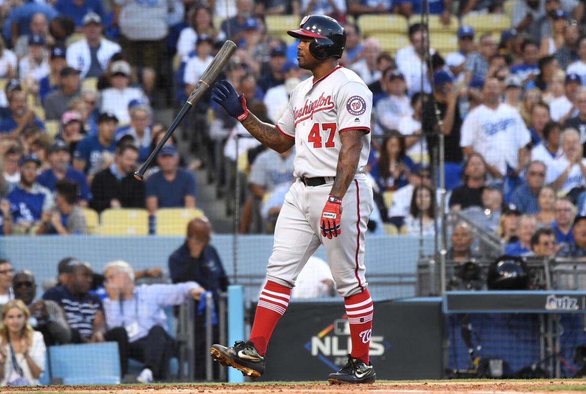Washington Nationals first baseman Howie Kendrick tosses his bat after striking out.