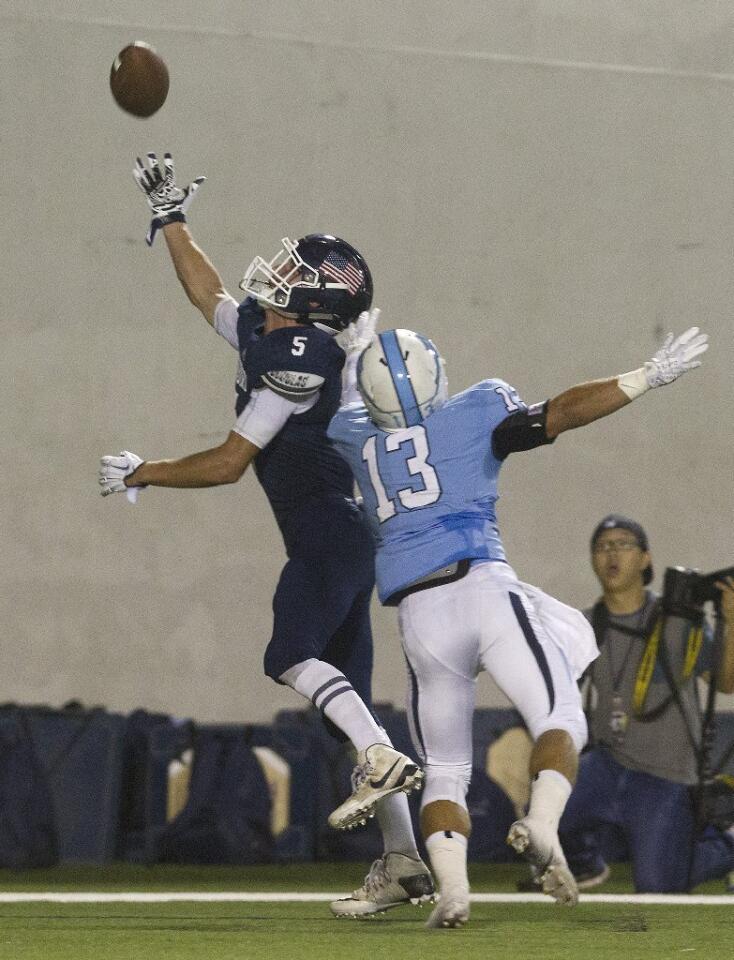 Newport Harbor High's Jack Rapillo (5) is unable to make the catch in the end zone defended by Corona del Mar's Blake Kormos (13).