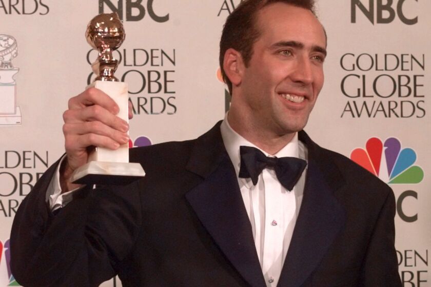 Nicolas Cage lifts the award for best actor in motion picture, drama, for his role in "Leaving Las Vegas" at the Golden Globe Awards, Sunday, Jan. 21, 1996, in Beverly Hills, Calif. (AP Photo/Mark J. Terrill)