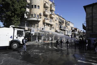 Israeli police use a water cannon to disperse protesters in an ultra-orthodox neighborhood of Jerusalem on Sunday.