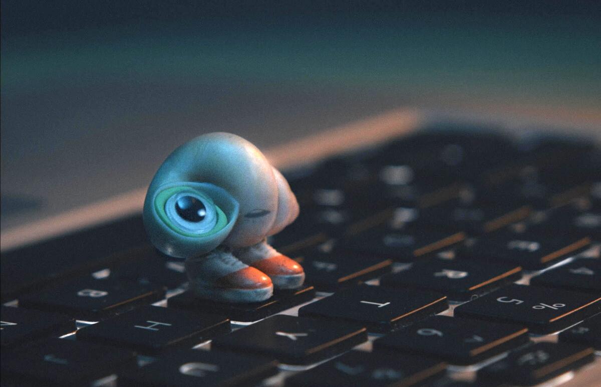 A little figurine on a laptop keyboard