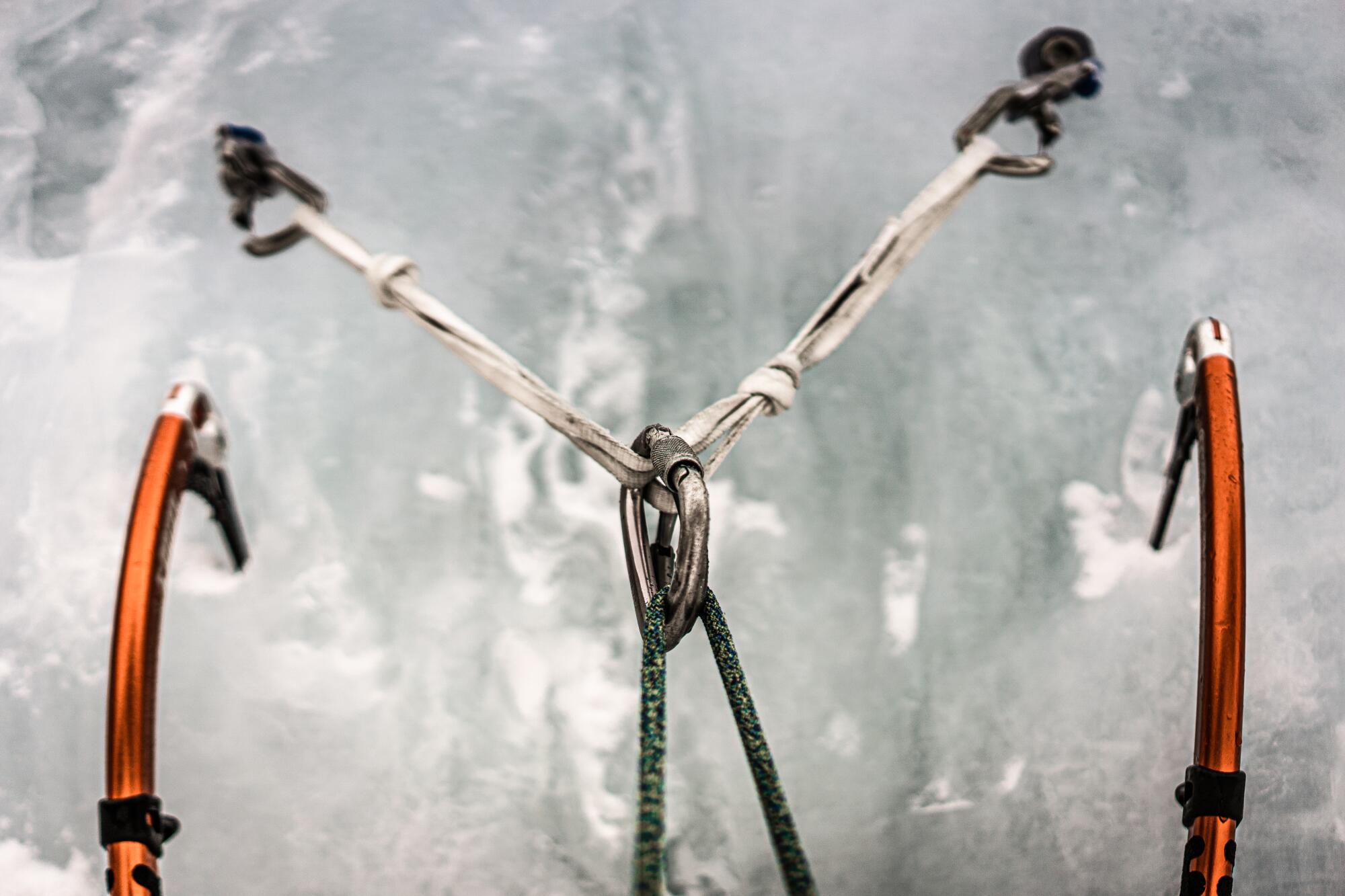 Two ice tools frame an anchor held in by ice screws (Richard Bae / For The Times)