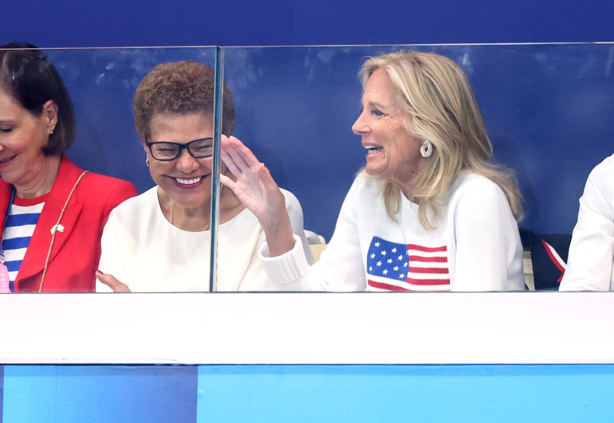 L.A. mayor Karen Bass, left, and First Lady Jill Biden share a laugh during an Olympic women's water polo match