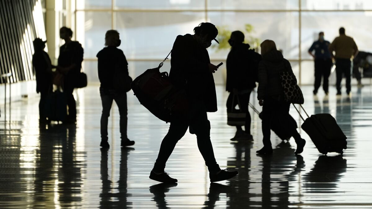 Silhouettes of passengers at an airport