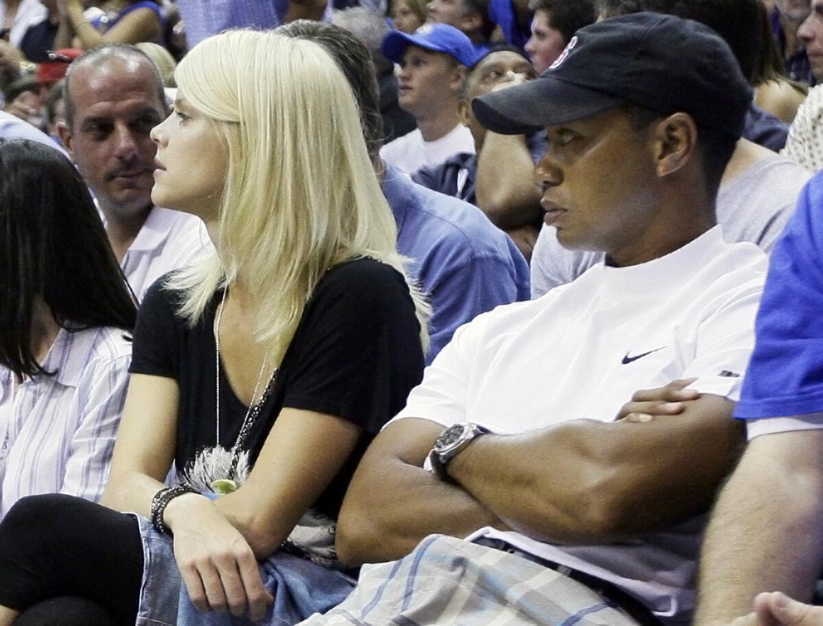 Tiger Woods and his wife, Elin Nordegren, watch Game 4 of the 2009 NBA Finals between the Lakers and Orlando Magic.