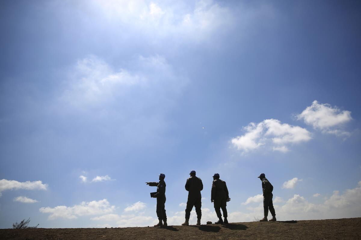 U.N. peacekeepers from the United Nations Disengagement Observer Force observe Syria's Quneitra province from Mt. Bental in the Israeli-controlled Golan Heights. Today, there are more than 100,000 U.N. peacekeepers, uniformed and civilian, in the field.