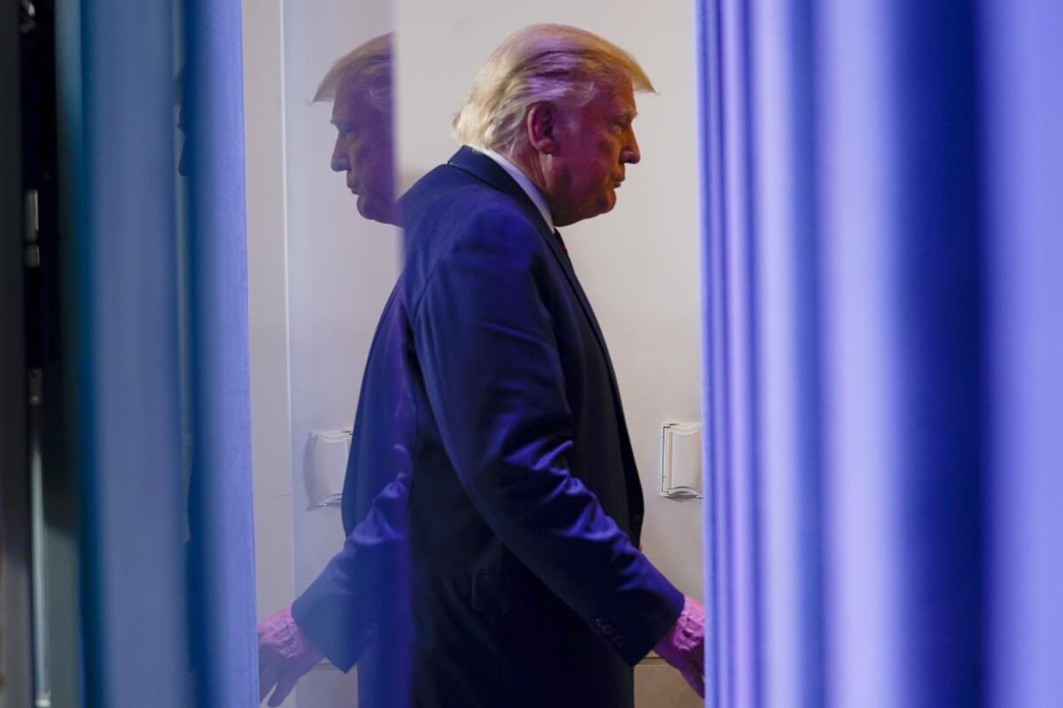 President Trump leaves a news conference Friday in the James S. Brady Press Briefing Room at the White House. 