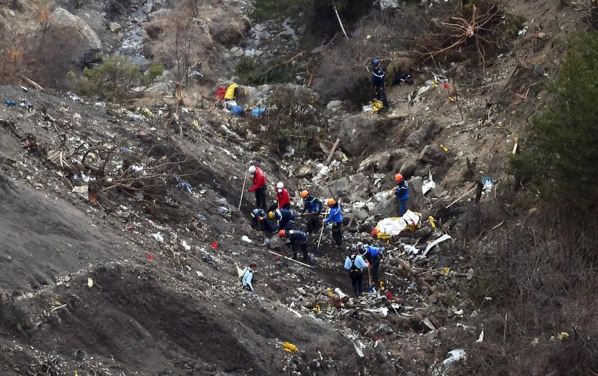This March 26, 2015, photo shows French gendarmes and investigators working at the crash site of the Germanwings Airbus A320.