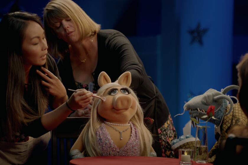 Miss Piggy gets a touch up during an interview with Aubrey Plaza on the Disney+ series "Muppets Now."