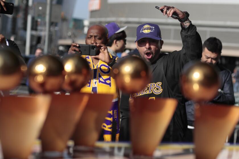 LOS ANGELES, CA, MONDAY, FEBRUARY 24, 2020 - Richard Miranda of Baldwin Park delivers a Kobe! chant as he views a diorama dedicated to the fallen Laker near Staples Center. (Robert Gauthier/Los Angeles Times)