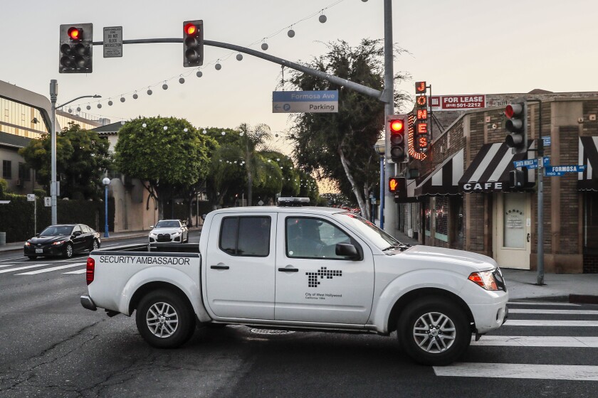 A white pickup truck with "security ambassador" written on the side 