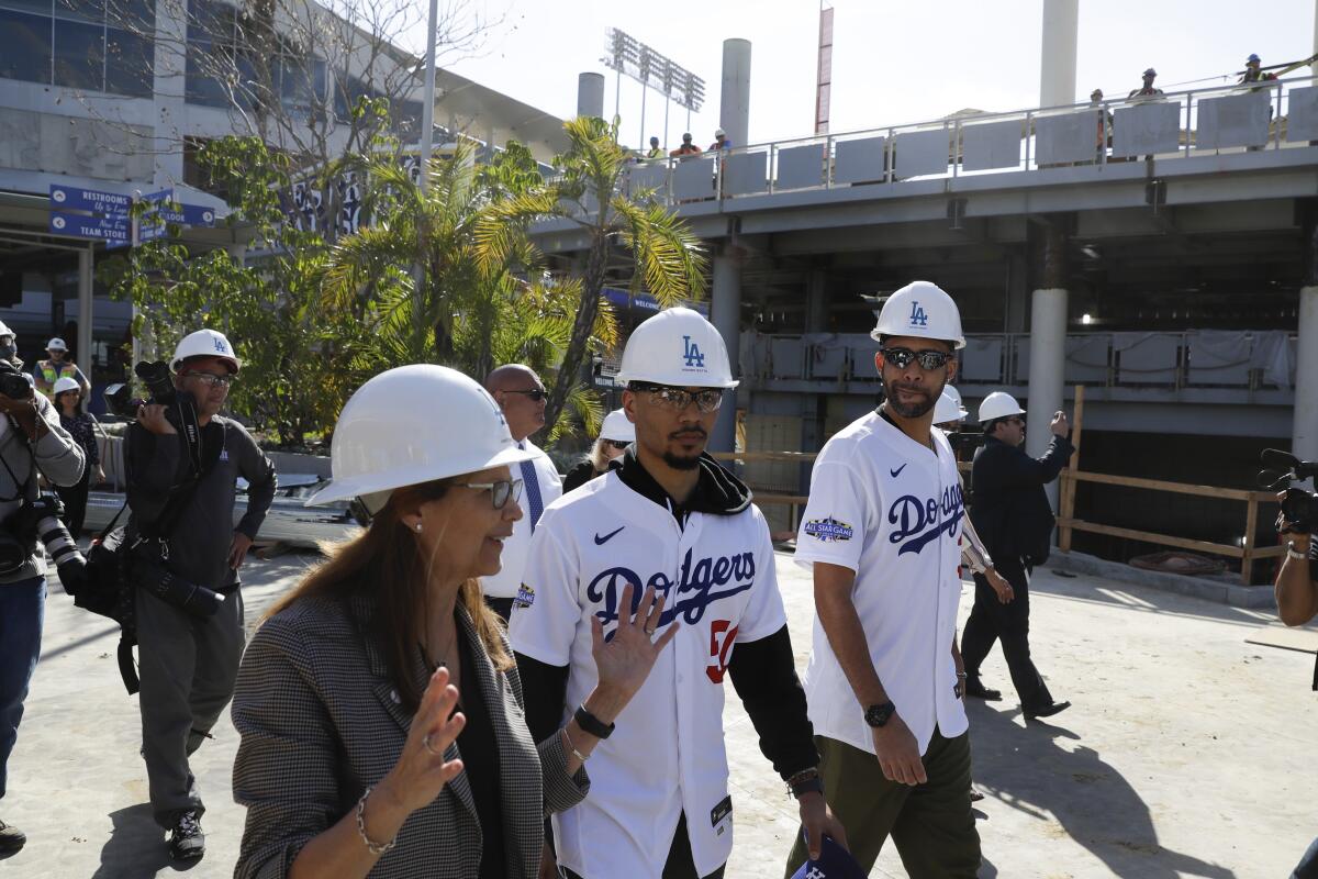 Dodgers players David Price, right, and Mookie Betts tour new construction with executive Janet Marie Smith on Feb. 12, 2020.