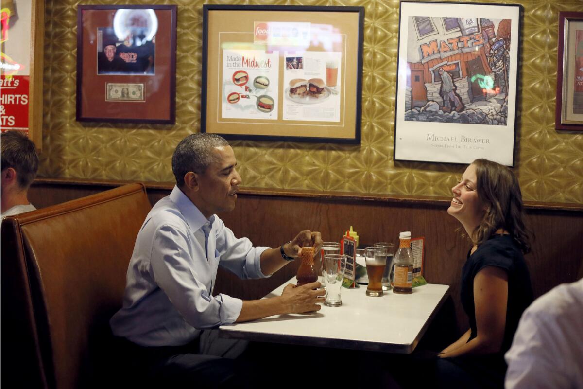 President Barack Obama talks with Rebekah Erler, of Minneapolis at Matts Bar before going to a town hall meeting at Minnehaha Park, Thursday, June 26, 2014, in Minneapolis. The president is in Minneapolis for the first in a series of Day-in-the-Life visits he pans to make across the country this summer. (AP Photo/The Star Tribune, Jerry Holt, Pool) ** Usable by LA and DC Only **