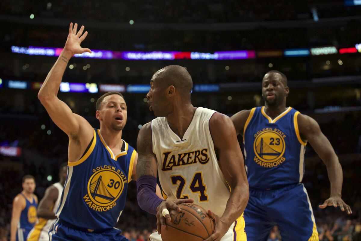 Kobe Bryant looks to pass while being defended by Golden State guard Stephen Curry on March 6 at Staples Center.