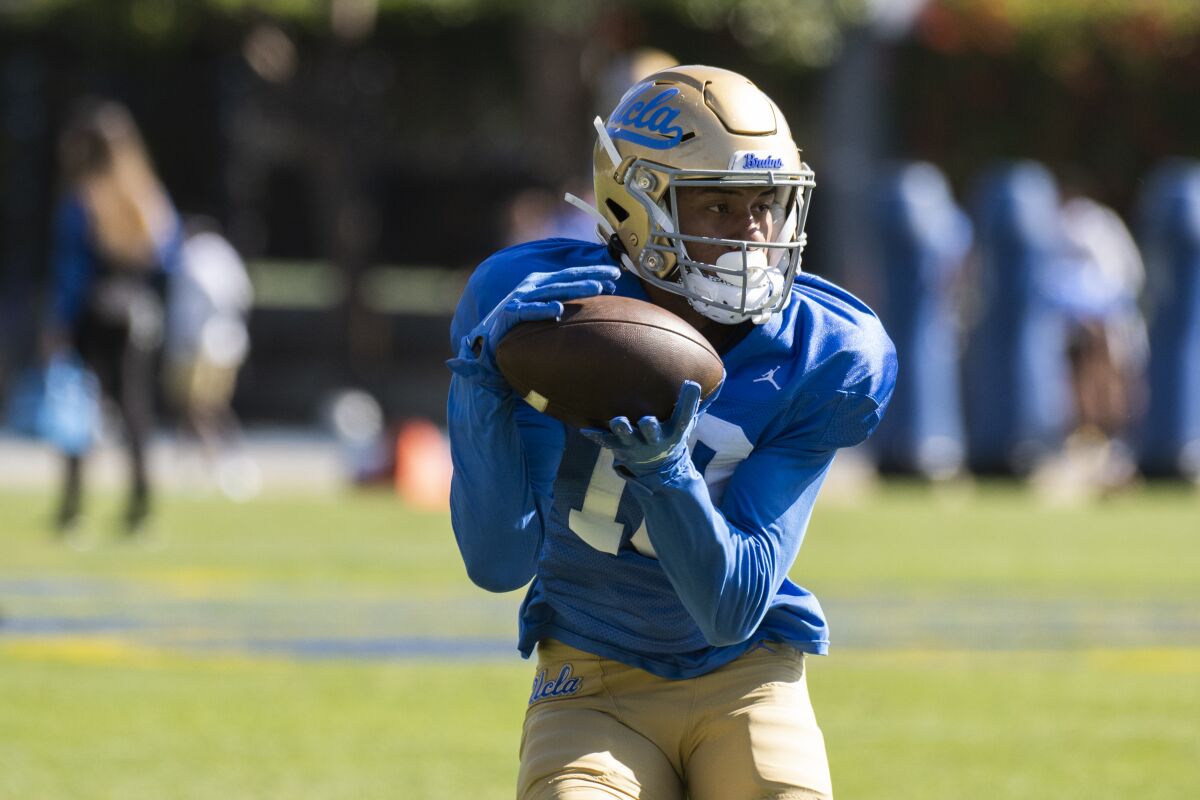 UCLA wide receiver Titus Mokiao-Atimalala catches the football during the team's Spring Showcase in Los Angeles.