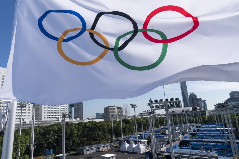 An Olympic flag flies over the the Ariake Tennis Center.