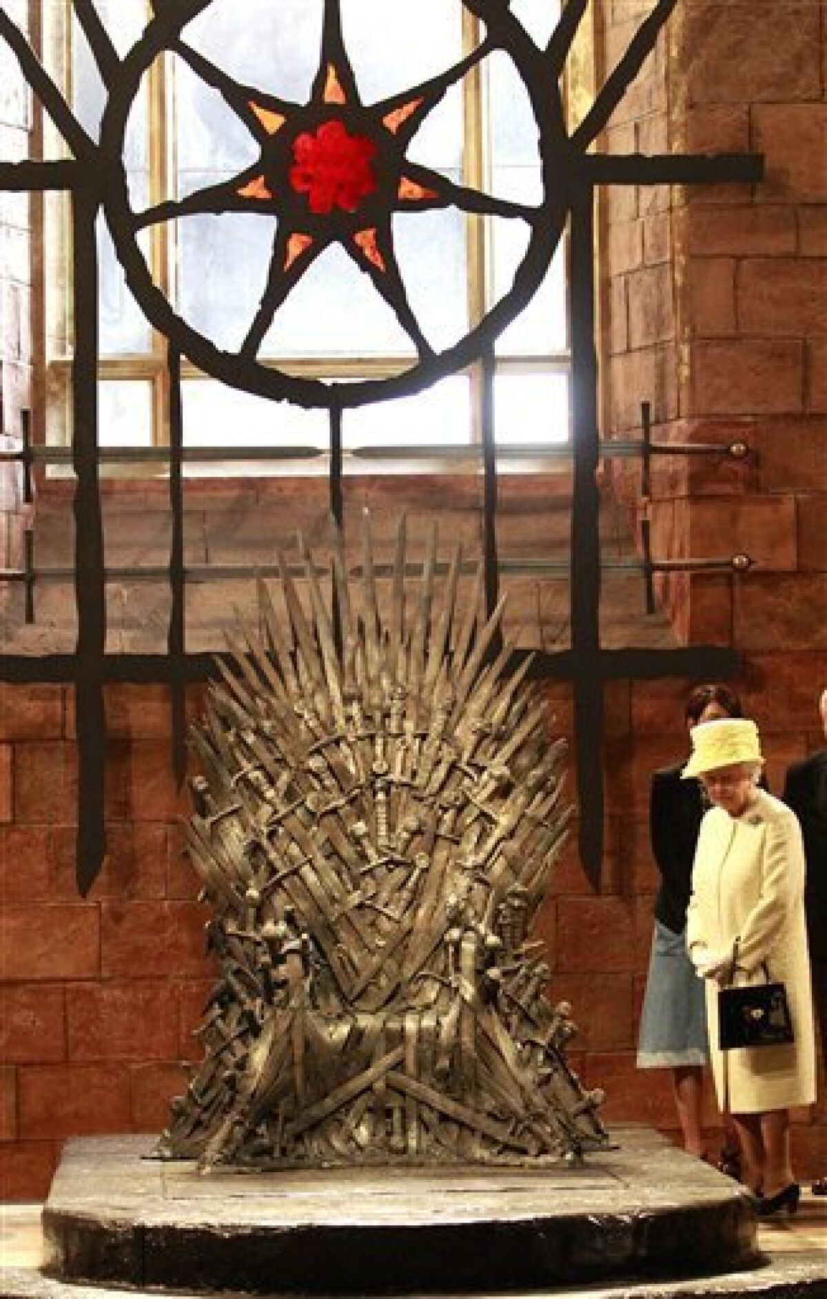 Britain's Queen Elizabeth II visits the throne room on the set of "Game of Thrones" in Belfast's Titanic Quarter, Northern Ireland, on June, 24, 2014.