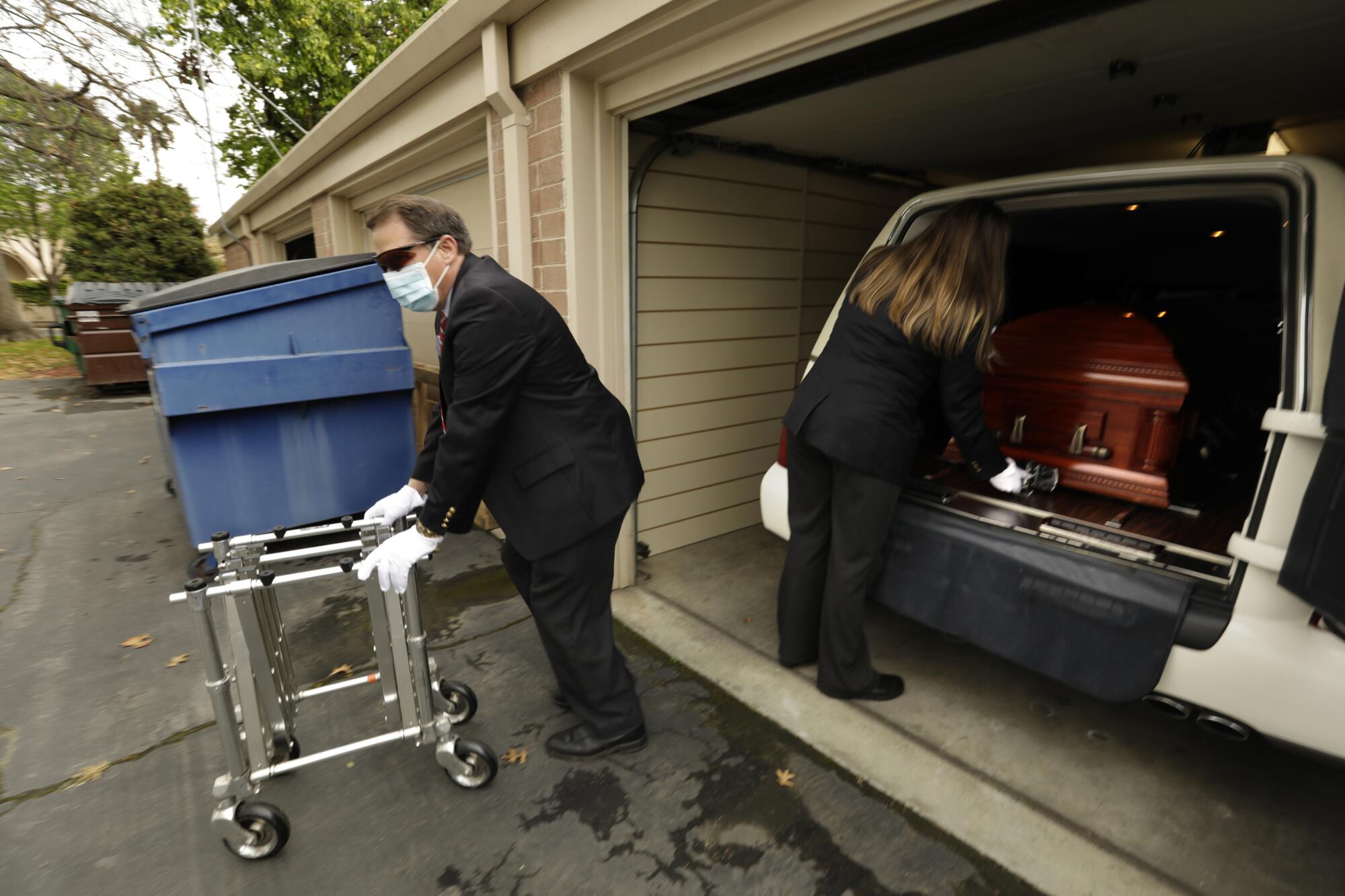 Funeral home workers followed strict protocols in handling the casket.