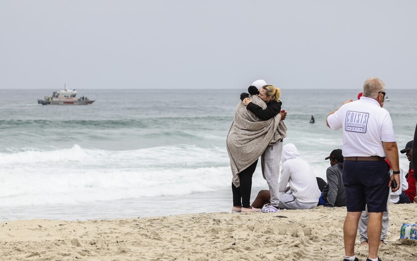 Family and friends of a missing 18-year-old swimmer gathered Wednesday at Mission Beach as lifeguards searched for his body.