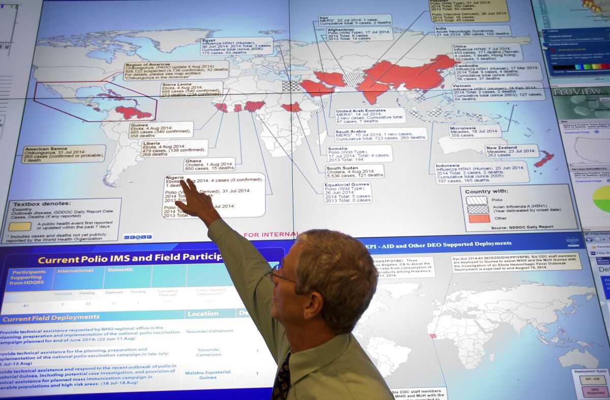 Steve Monroe, deputy director of the National Center for Emerging and Zoonotic Infectious Diseases at the U.S. Centers for Disease Control and Prevention, looks over a map showing global health issues at the agency's Emergency Operations Center in Atlanta.