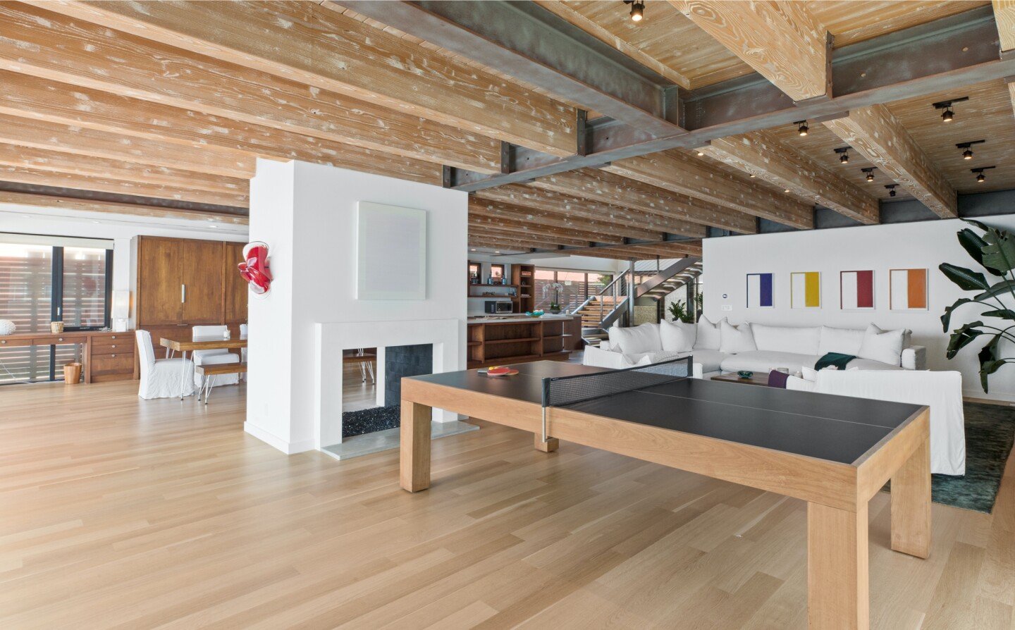 The architectural beach house expands to two levels of wood decks overlooking the ocean.