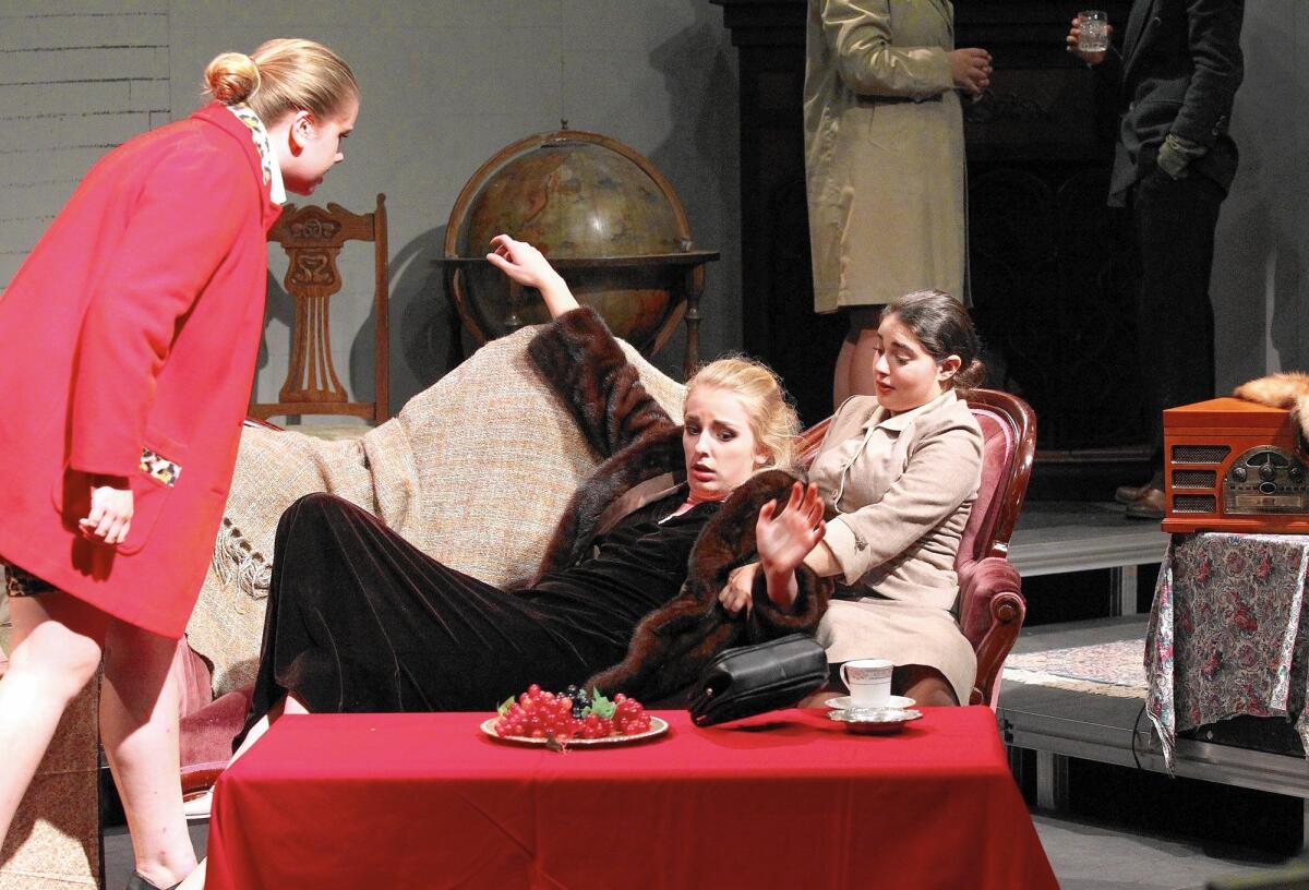 Sabrina Vonbogenberg, in black, falls into the lap of Vita Mucci as they rehearse for their fall production "The Mouse Trap," at Newport Harbor High. The students arranged rehearsals, costumes, props and set to complete the production after their teacher left at the end of the prior school year.