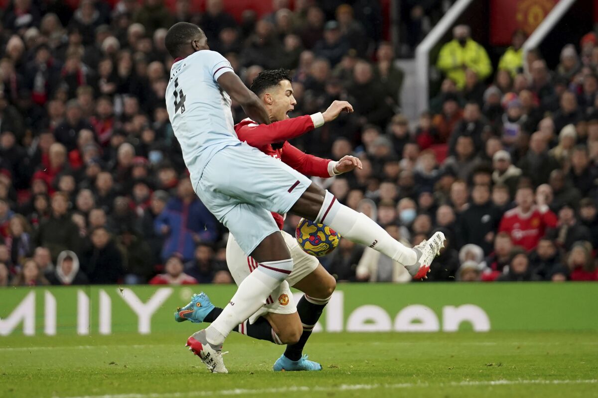 Manchester United's Cristiano Ronaldo, right, and West Ham's Kurt Zouma vie for the ball during the English Premier League soccer match between Manchester United and West Ham at Old Trafford stadium in Manchester, England, Saturday, Jan. 22, 2022. (AP Photo/Dave Thompson)
