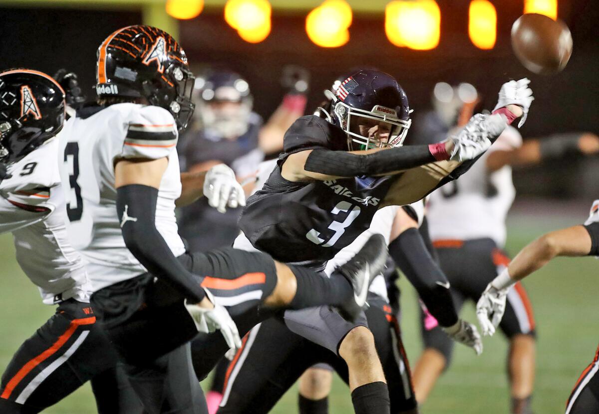 Johnny Chaix  of Newport Harbor blocks a punt by Tyler Moses (3) which led to a touchdown during a Sunset League game.