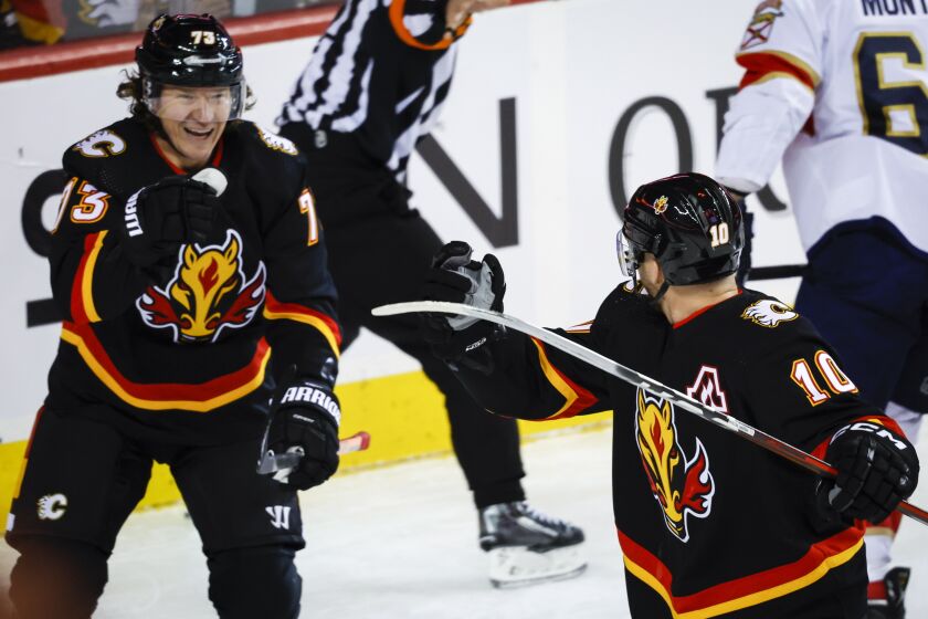 Calgary Flames forward Jonathan Huberdeau, right, celebrates his goal against the Florida Panthers with Tyler Toffoli during the first period of an NHL hockey game Tuesday, Nov. 29, 2022, in Calgary, Alberta. (Jeff McIntosh/The Canadian Press via AP)