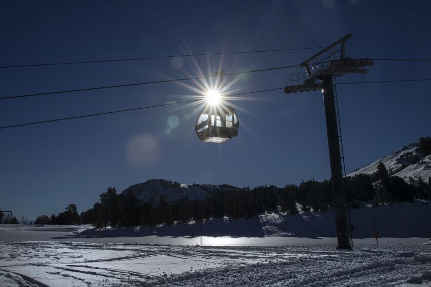 MAMMOTH LAKES, CA - October 27 2021: Bright morning sunshine sets the Panorama Gondola aglow at Mammoth Mountain on Wednesday, Oct. 27, 2021 in Mammoth Lakes, CA. The ski resort will open two weeks earlier than scheduled thanks to recent snow storms. (Brian van der Brug / Los Angeles Times)