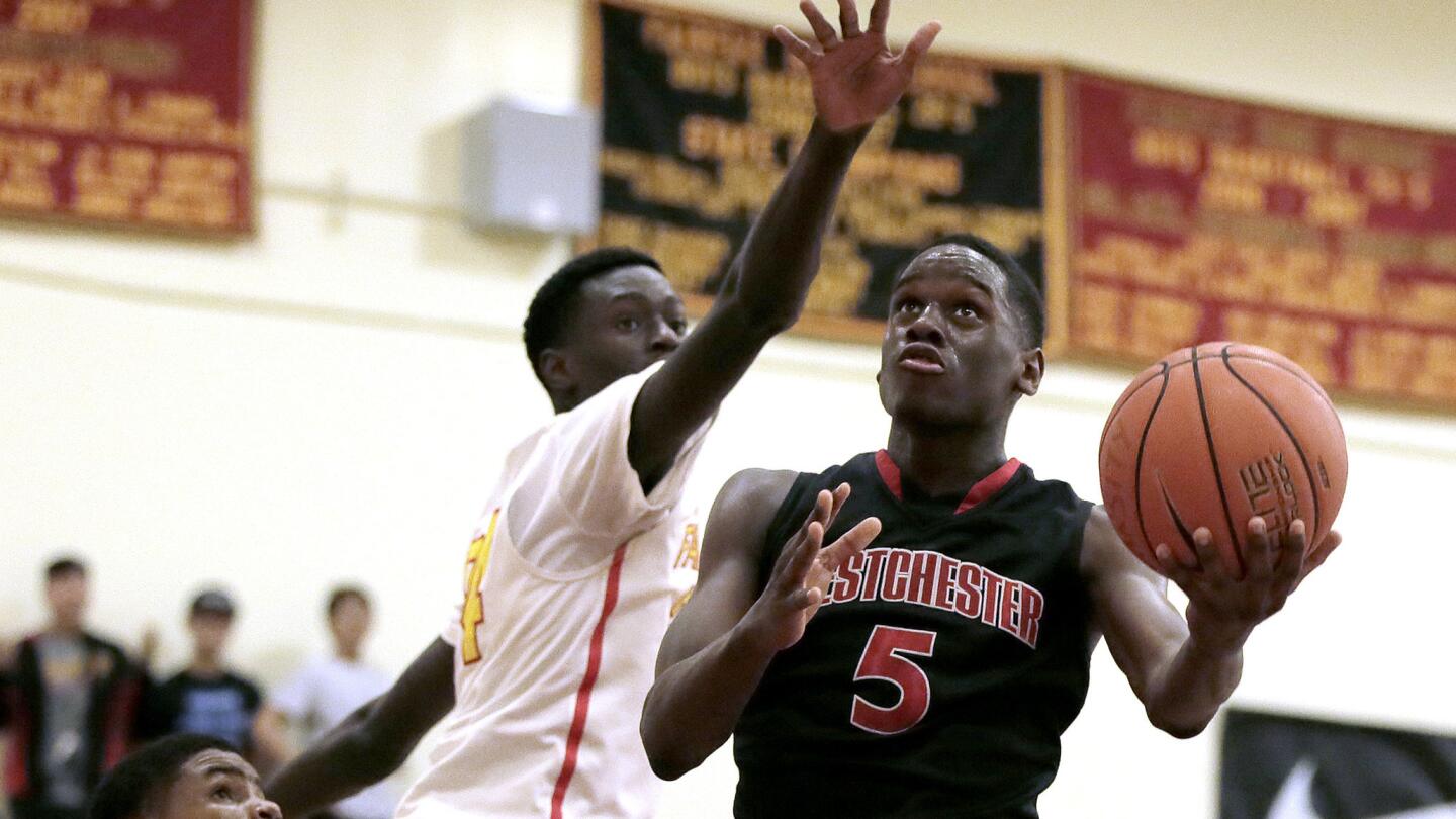 Westchester L'Kielynn Taylor (5) drives to the basket against Fairfax's Babacar Thiombane.