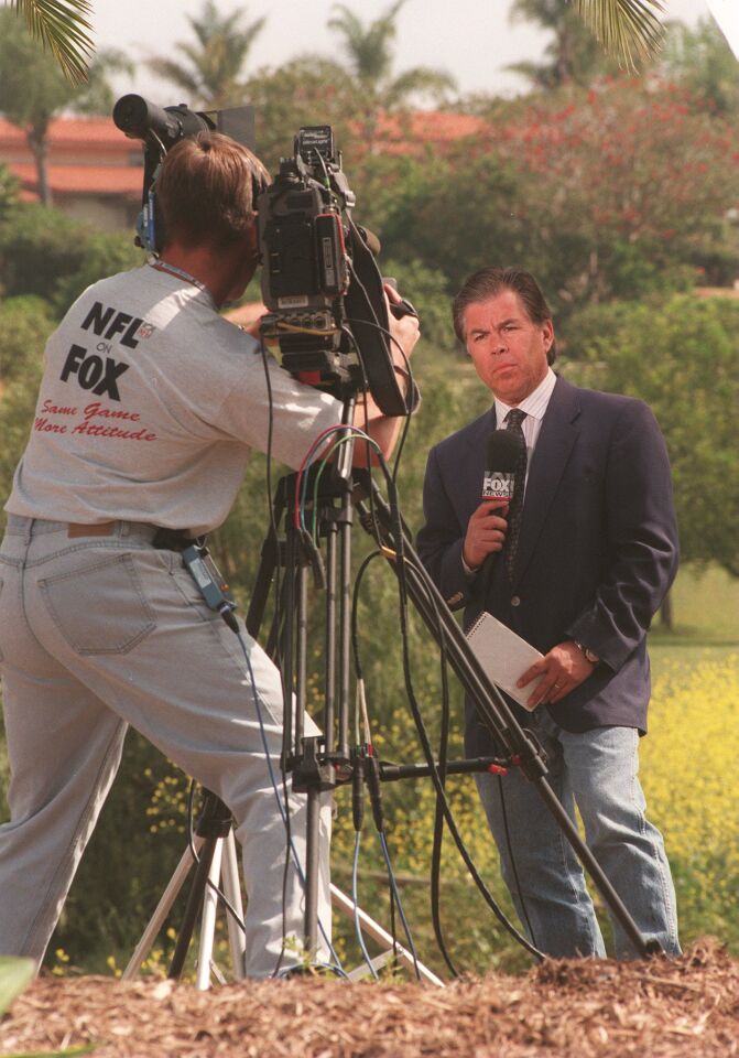 Fox Network photographer Scott King of Los Angeles, left, worked with reporter Fred Villanueva during a live spot near the Rancho Santa Fe mansion where the bodies of 39 Heaven's Gate members were found on March 26, 1997.