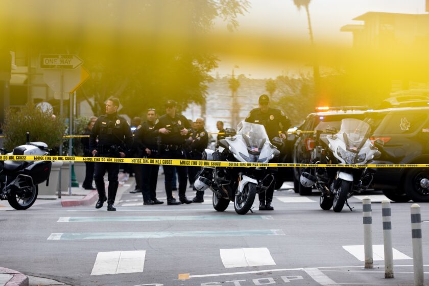 San Diego, California - March 03: The San Diego Police Department and other officials investigate an officer involved shooting where an officer was injured in downtown on Thursday, March 3, 2022 in San Diego, California. (Ana Ramirez / The San Diego Union-Tribune)