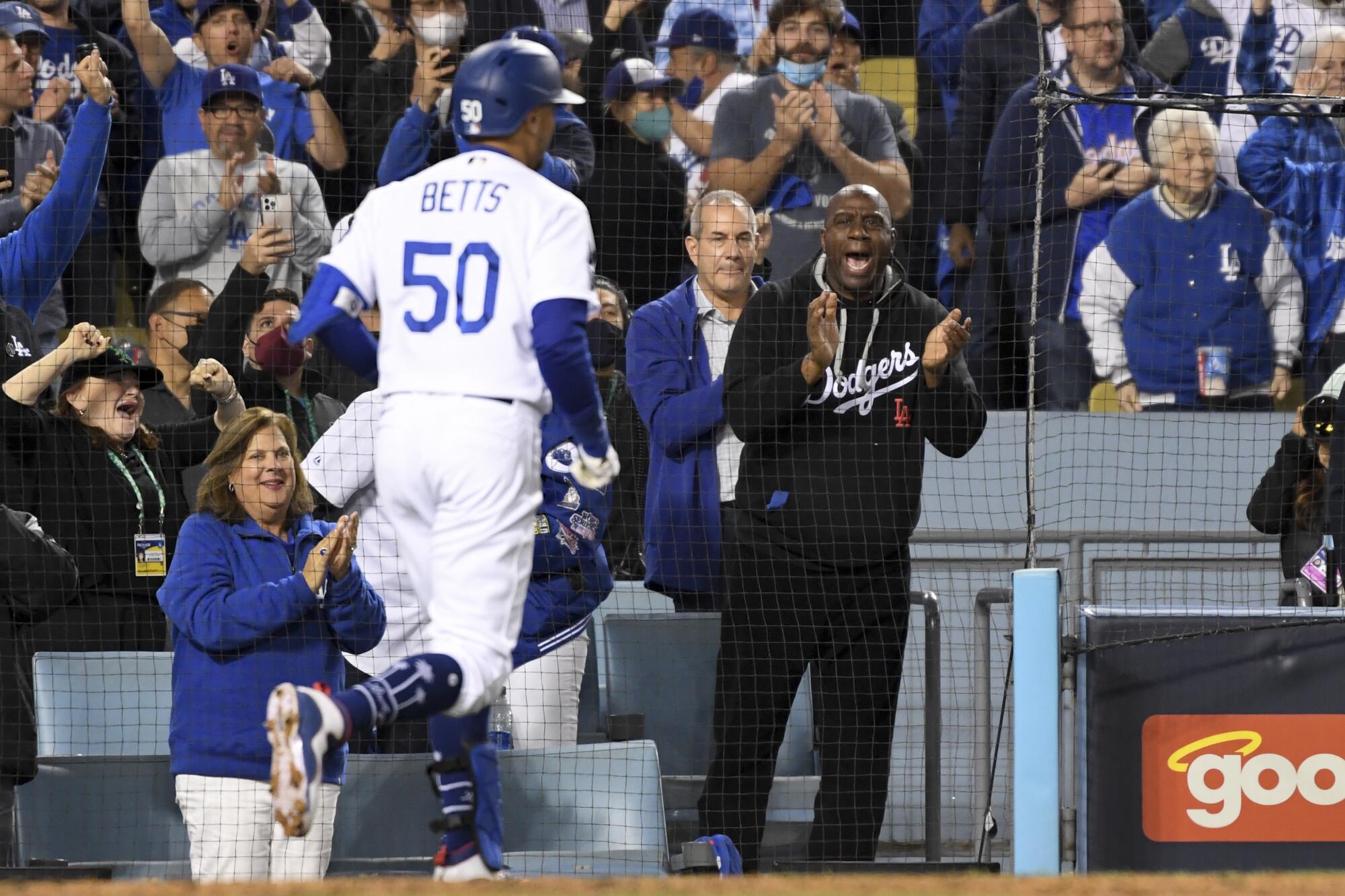 LoMagic Johnson cheers on Dodgers' Mookie Betts.