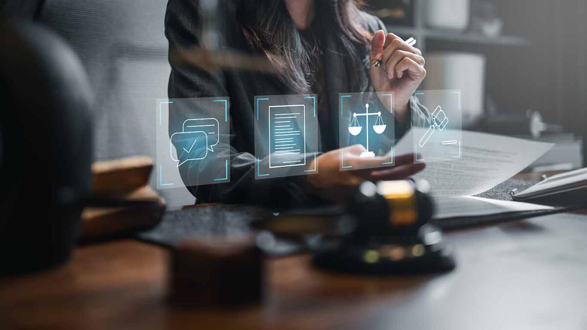 Professional woman sitting with a computer and paper, possibly in a law office or a courtroom