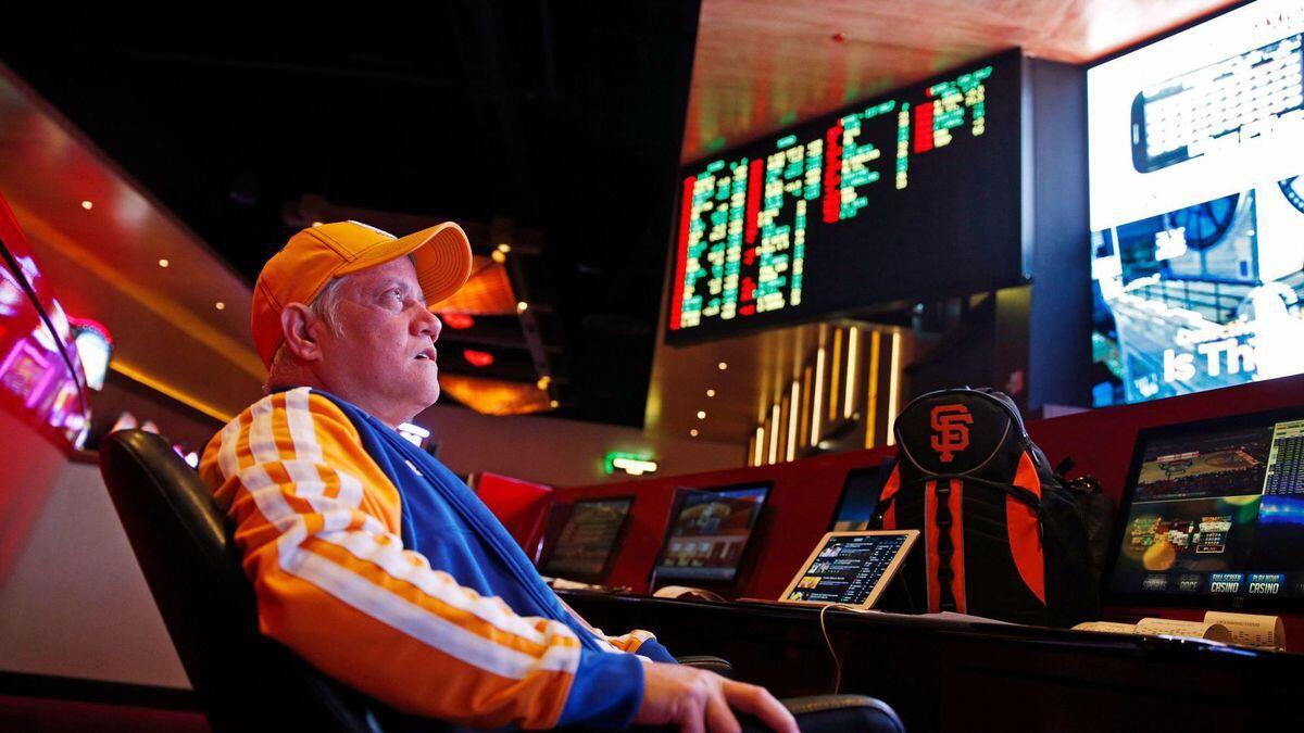 Amado Nanalang watches basketball games while making bets at a sports book in Las Vegas. 