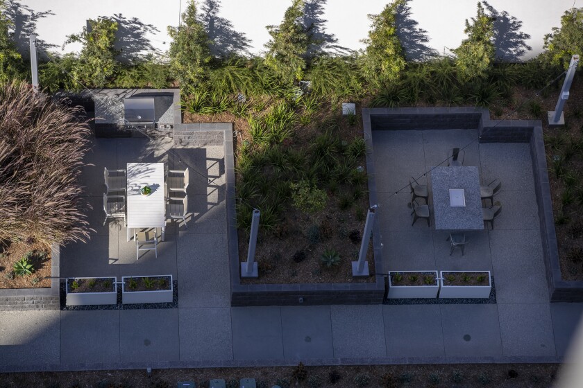 An aerial view of the grills, Korean barbecue and open-air dining areas on the one-acre rooftop park and pool at Kurve. 