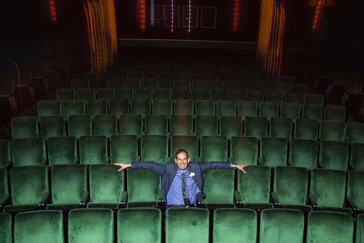 A man sits in an empty theater