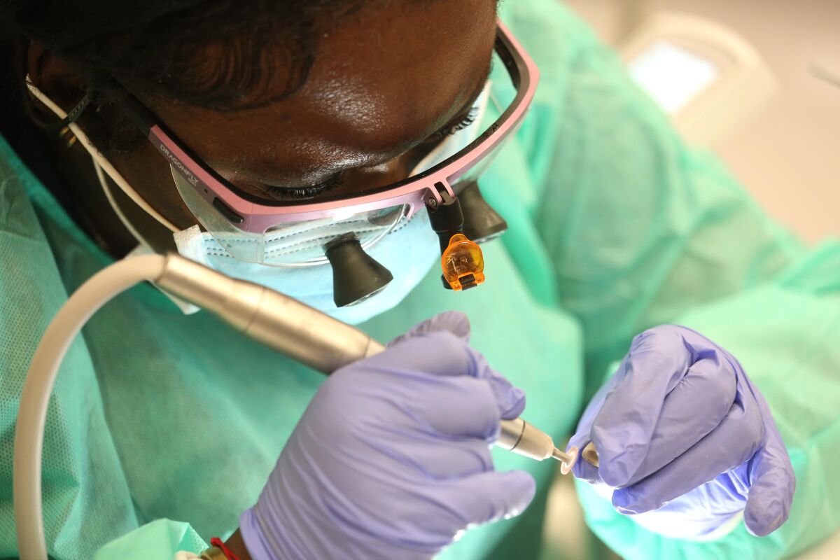     Somkene Okwuego makes a crown during a dentistry class.