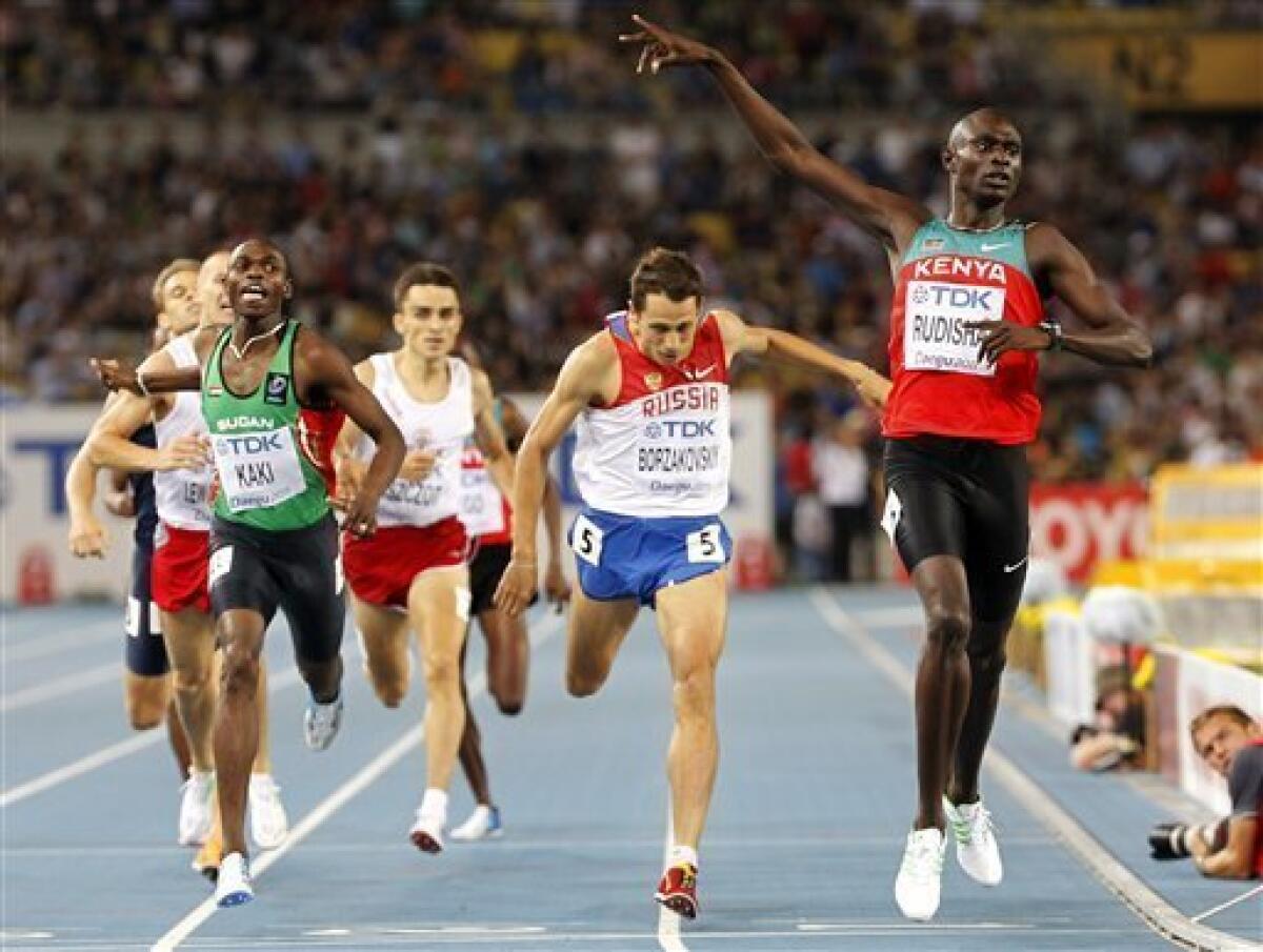 Kenya's David Lekuta Rudisha, right, reacts as he crosses the finish line ahead of Sudan's Abubaker Kaki, left, and Russia's Yuriy Borzakovskiy, center, in the Men's 800m final at the World Athletics Championships in Daegu, South Korea, Tuesday, Aug. 30, 2011. (AP Photo/Anja Niedringhaus)