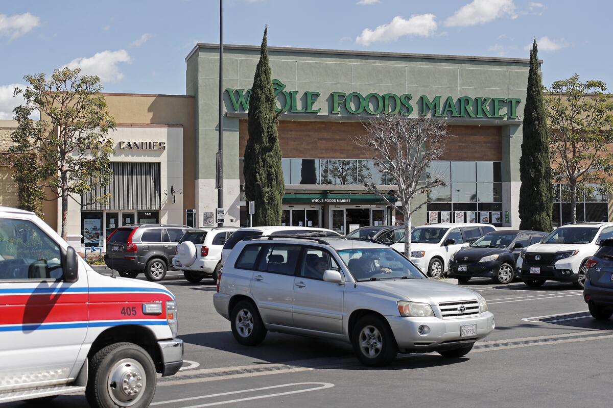 An employee of the Whole Foods Market at the Bella Terra mall in Huntington Beach, pictured Thursday, tested positive for the coronavirus that causes COVID-19, the company said.