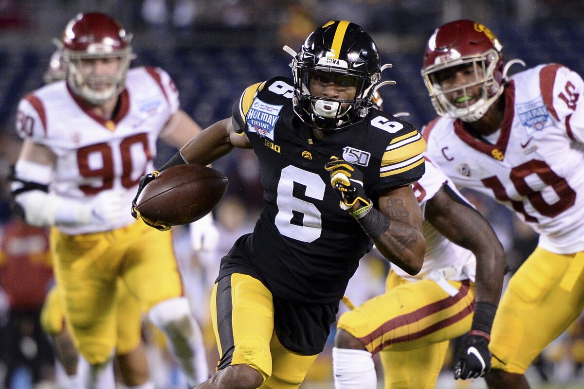 FILE - In this Dec. 27, 2019, file photo, Iowa wide receiver Ihmir Smith-Marsette (6) runs with the ball for a touchdown during the first half of the Holiday Bowl NCAA college football game against Southern California in San Diego. Smith-Marsette knew he messed up when Iowa City police pulled him over after clocking him driving 74 mph in a 30 zone in the wee hours of Nov. 1. His career was not over. In fact, coach Kirk Ferentz offered support, putting out a statement hours later saying the arrest was out of character and that Smith-Marsette was a great teammate. (AP Photo/Orlando Ramirez, File)