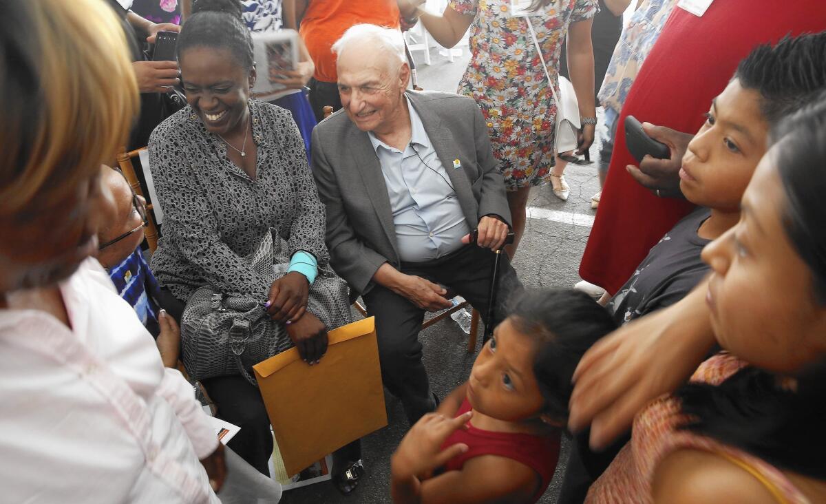 Architect Frank Gehry is surrounded by children at the unveiling of his design for the future Watts campus of the Children's Institute.