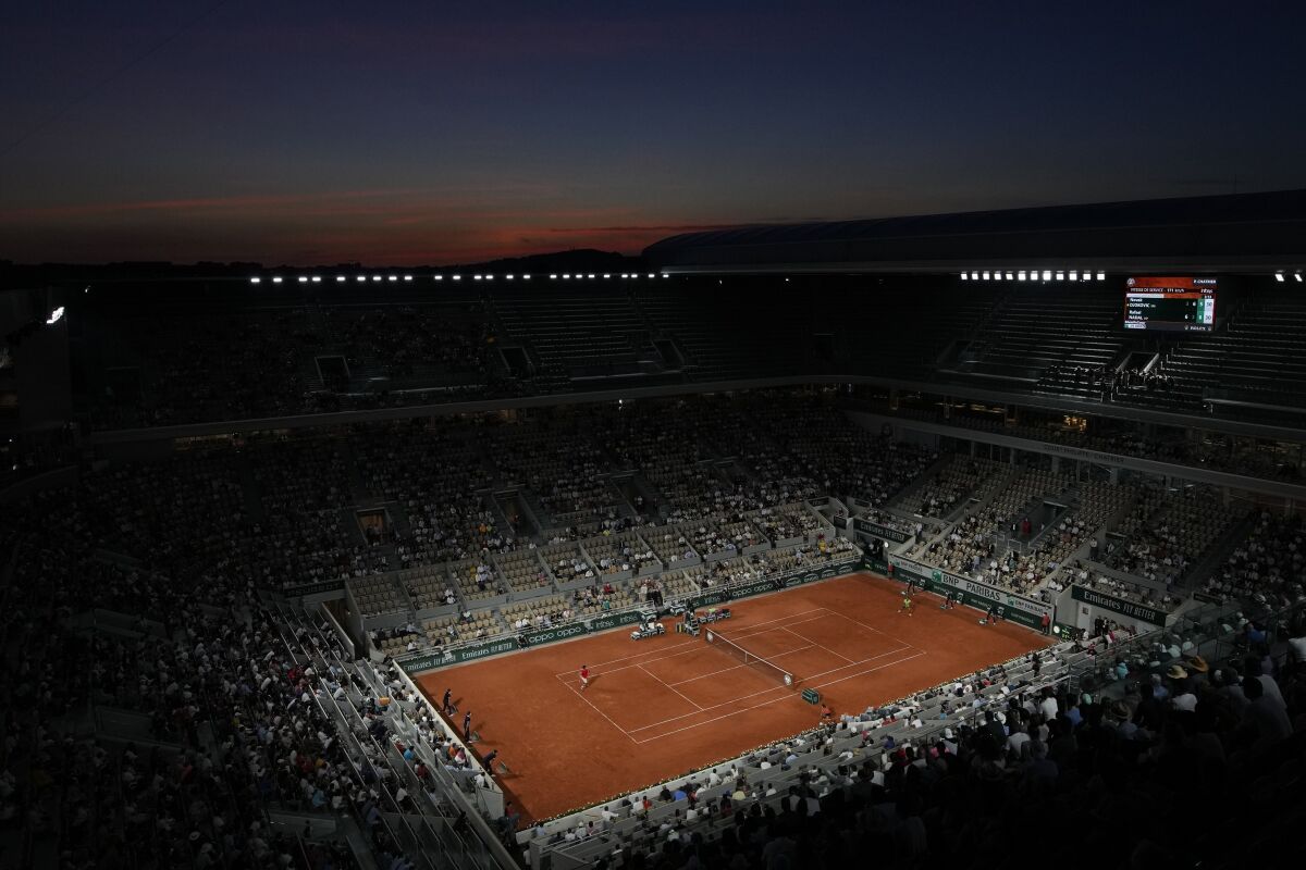 FILE - Spain's Rafael Nadal, right, plays Serbia's Novak Djokovic during their semifinal match of the French Open tennis tournament at the Roland Garros stadium Friday, June 11, 2021 at sunset in Paris. All four Grand Slam tennis tournaments will now use a 10-point tiebreaker when matches reach 6-6 in the final set. The Grand Slam Board announced the trial move, taking effect immediately, on behalf of the Australian, French and U.S. Opens and Wimbledon on Wednesday, March 16, 2022. (AP Photo/Christophe Ena, File)