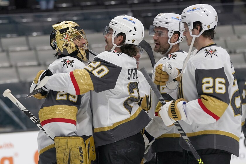 Vegas Golden Knights goaltender Marc-Andre Fleury, left, celebrates with Chandler Stephenson, William Carrier and Mattias Janmarkright, after the Golden Knights defeated the San Jose Sharks in an NHL hockey game in San Jose, Calif., Wednesday, May 12, 2021. (AP Photo/Jeff Chiu)