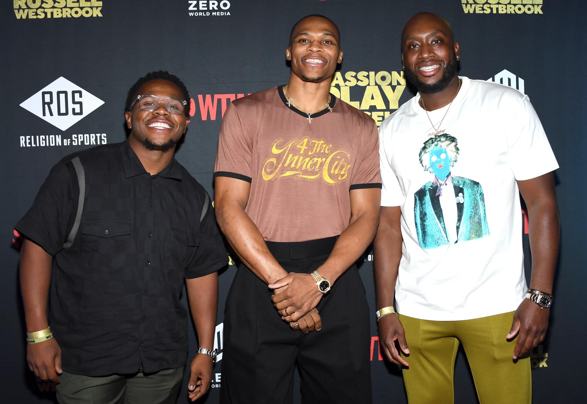 Russell Westbrook is flanked by his brother Raynard, left, and friend Donnell Beverly at the premier of his documentary.